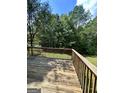 Wooden deck overlooks a private backyard with lush trees at 4020 Grady Smith Rd, Loganville, GA 30052