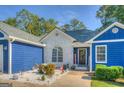 Close-up of a charming home's entrance featuring a brick facade, manicured landscaping, and a welcoming front door decor at 2037 Emily Dr, Social Circle, GA 30025