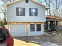 Two-story house featuring a stone facade and a double garage at 5303 Kemper Pl, Stone Mountain, GA 30088