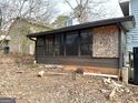 Enclosed sunroom with glass windows needing repair at 5303 Kemper Pl, Stone Mountain, GA 30088