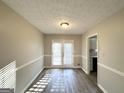 Bright dining room with hardwood floors and French doors at 3786 Glen Mora Dr, Decatur, GA 30032