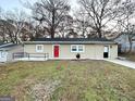 Charming ranch home with red front door and manicured lawn at 2920 Springside Se Pl, Atlanta, GA 30354