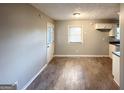 Simple dining area with wood-look floors and access to kitchen at 3226 Browns Mill Se Rd, Atlanta, GA 30354