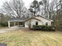House exterior featuring a carport and small deck at 220 Mountain View Cir, Covington, GA 30016