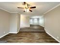 Open living area with hardwood floors and ceiling fan at 220 Mountain View Cir, Covington, GA 30016