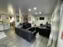 Spacious living room featuring black leather sofas and gray flooring at 2572 Plantation, Atlanta, GA 30344