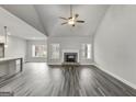 Open living room with vaulted ceiling, fireplace, and hardwood floors at 8950 Callaway Drive, Winston, GA 30187