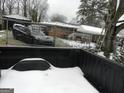 Large backyard with a partially visible home and snow-covered ground at 1434 Butler St, Jonesboro, GA 30236