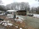 Ranch home with a deck, partially fenced yard, and snow on the ground at 1434 Butler St, Jonesboro, GA 30236