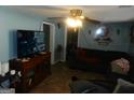 Living room featuring a sofa, TV, and wood cabinet at 1434 Butler St, Jonesboro, GA 30236