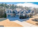 Stunning aerial view of a two-story home with a large yard and driveway at 4960 Shade Creek Xing, Cumming, GA 30028