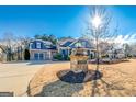 Charming two-story home with stone mailbox and a beautiful manicured lawn at 4960 Shade Creek Xing, Cumming, GA 30028