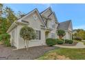 Two-story house with beige exterior, landscaping, and a walkway at 125 Fawn Brook Pass, Fayetteville, GA 30215