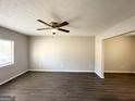 Bright living room with dark gray vinyl flooring and ceiling fan at 2959 Fairburn Rd, Atlanta, GA 30331