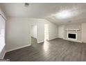 Bright living room featuring gray flooring and a stone fireplace at 1618 Old Alabama Rd, Austell, GA 30168