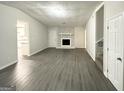 Spacious living room with gray flooring and a stone fireplace at 1618 Old Alabama Rd, Austell, GA 30168