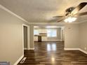 Open living room with hardwood floors and view into kitchen at 121 Pine Forest Dr, Dallas, GA 30157