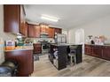 Spacious kitchen with a central island, wooden cabinets, and modern stainless-steel appliances at 319 Allegrini Dr, Atlanta, GA 30349