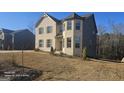 Two-story home with brick and gray siding, and landscaping at 352 Traditions Ln, Hampton, GA 30228