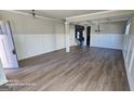 Spacious living room with hardwood floors and elegant wainscoting at 352 Traditions Ln, Hampton, GA 30228