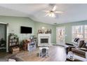 Living room with fireplace, hardwood floors, and large windows at 3153 Sweetbriar Dr, Villa Rica, GA 30180