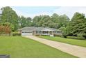 Brick ranch home with a spacious lawn and driveway at 100 Aspen Way, Fayetteville, GA 30214