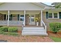 Charming front porch with white columns and rocking chairs at 100 Aspen Way, Fayetteville, GA 30214