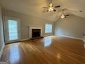 Bright living room featuring hardwood floors and a fireplace at 235 Long Dr, Mcdonough, GA 30253