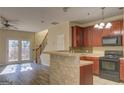 Kitchen with dark wood cabinets, black appliances, and breakfast bar at 168 Ellis Dr, Conyers, GA 30012