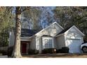 Charming single Gathering home with a large tree in the front yard and a red front door at 3700 Mays Sw Xing, Atlanta, GA 30331