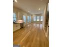 Bright living room with hardwood floors and access to kitchen at 165 Kelmscott Ln., Fayetteville, GA 30214