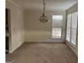 Bright dining room with large windows and chandelier at 10420 Summer Creek Dr, Alpharetta, GA 30022