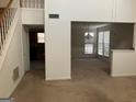 View of living room and stairs leading to upper level at 10420 Summer Creek Dr, Alpharetta, GA 30022