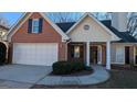 Brick and beige siding house with a two-car garage at 2673 Northforke Ct, Tucker, GA 30084