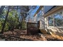 Home's backyard with a wooden deck and surrounding trees at 2673 Northforke Ct, Tucker, GA 30084