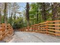 Long driveway leading to a modern home in a wooded area at 1153 Dawn View Nw Ln, Atlanta, GA 30327