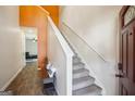 Bright entryway with staircase, wood floors, and an orange accent wall at 429 Burgundy Se Ter, Atlanta, GA 30354