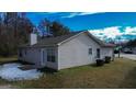 Rear view of house showing patio and landscaping at 9299 Tee Trce, Riverdale, GA 30274