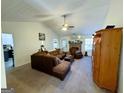 Spacious living room with vaulted ceiling, fireplace and L-shaped sofa at 504 Plantation Creek Dr, Loganville, GA 30052