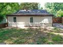 Home's rear elevation, showcasing a patio and grassy backyard at 1256 Elizabeth Sw Ave, Atlanta, GA 30310