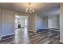 Open concept dining room with new flooring and chandelier at 5495 Reynolds Rd, Morrow, GA 30260