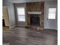 Stone fireplace and grey vinyl flooring in living room at 5495 Reynolds Rd, Morrow, GA 30260