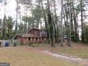Brick ranch house with a large yard and mature trees. Needs some TLC at 3816 King Henry Sw Rd, Atlanta, GA 30331