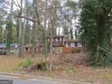 Brick ranch house with a large yard and mature trees. Needs some TLC at 3816 King Henry Sw Rd, Atlanta, GA 30331