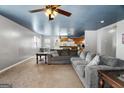 Open living space with a gray sectional sofa and kitchen view at 5552 Smithfield Rd, Bowdon, GA 30108