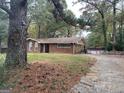 Brick ranch house with a long driveway and mature trees at 793 Pixley Dr, Riverdale, GA 30296