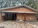 Peach-colored house with covered porch and detached garage at 793 Pixley Dr, Riverdale, GA 30296