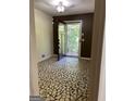 Small entryway with unique patterned tile flooring at 6074 Shallow Wood Ln, Douglasville, GA 30135
