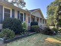 House exterior showcasing landscaping and a covered porch at 6074 Shallow Wood Ln, Douglasville, GA 30135