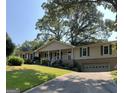 Ranch home with a long driveway and large trees at 6074 Shallow Wood Ln, Douglasville, GA 30135